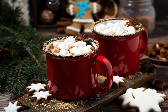 cozy winter drink hot chocolate in red mugs on wooden table