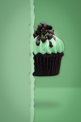 Flying cupcakes on green background, idea minimal concept for new year, christmas holliday