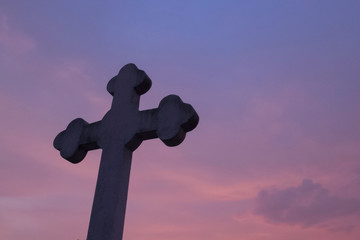 silhouette of cross on top cemetery  sunset time