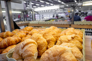 The fresh bakery set such as donut , bread  etc in the plastic tray for sell in the shop.