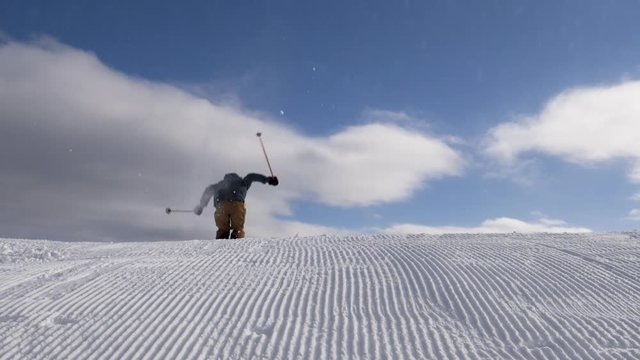 Slow motion - Freestyle skier jumping over kicker at snow park