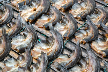 Fototapeta premium Dried fish on a bamboo panel.