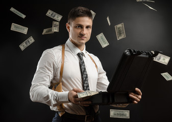 a man in a suit jacket with a case of money