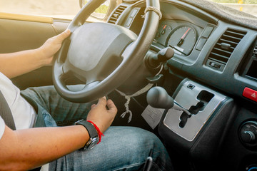 Man is driving vehicle while working or going to somewhere with flare from the outside in the sunny day. 