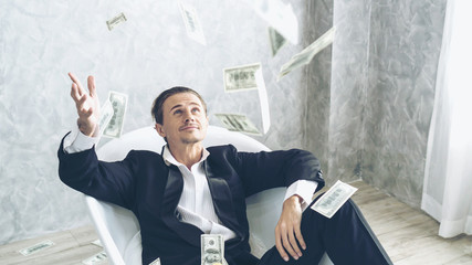 Happy business man very rich guy throw money dollar bills in air like rain money bill and banknotes...