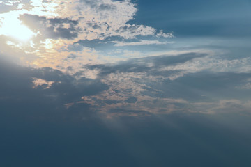 The image of clouds in the blue sky. The sun shines through the clouds. Background. Cropped shot, close-up, nobody