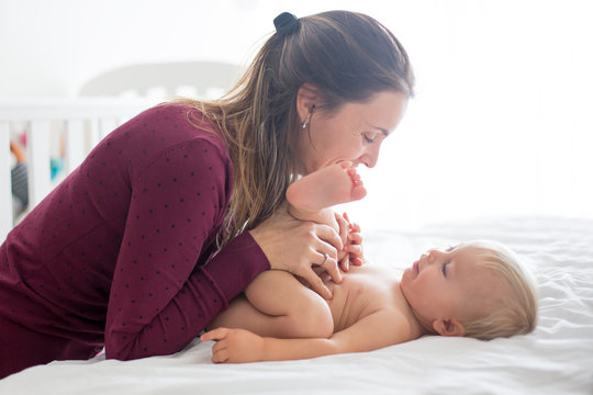 Young Mom, Changing Baby Diaper After Bath