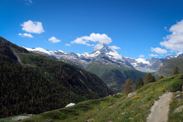 Fototapeta na wymiar Scenic bright view of Matterhorn and clouds around, Swiss Alps near Zermatt