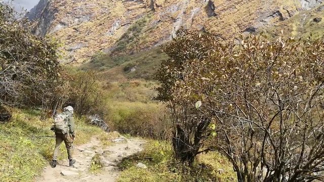 Hiker walking on trekking trail to Annapurna Base Camp, Himalayas, Nepal. POV.