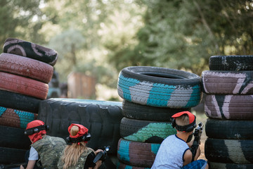 Obraz premium Kids playing lasertag on special polygon with shelter