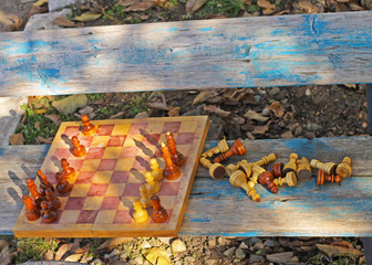 Chess in the park on the bench.