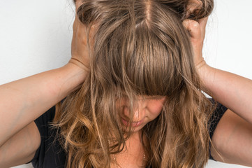 Fototapeta premium Depressed woman with hands in her hair