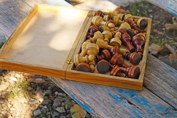 Chess in the park on the bench.
