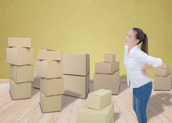 woman suffering from backache while moving boxes