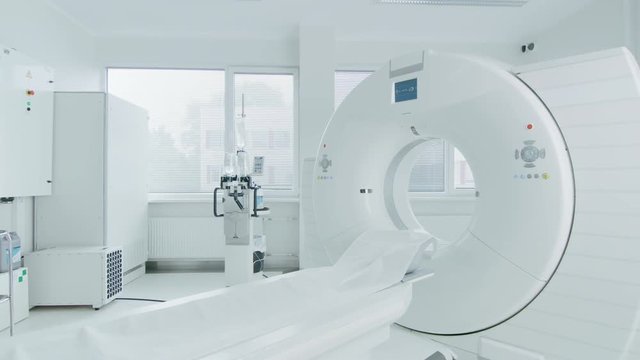 Medical CT or MRI or PET Scan Standing in the Modern Hospital Laboratory. Technologically Advanced and Functional Mediсal Equipment in a Clean White Room. Slowly Moving Side Shot.