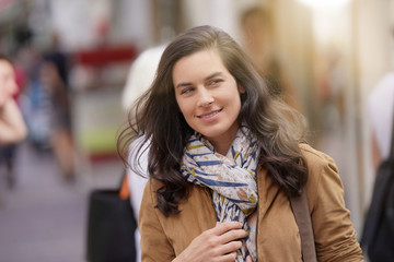 Fototapeta premium Attractive brunette woman walking in town