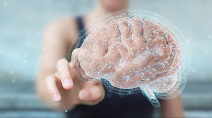 Businesswoman using digital 3D projection of a human brain 3D rendering