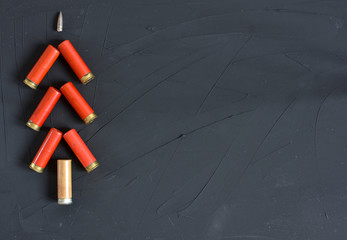 New Year concept. Congratulations for the hunter with hunting cartridges on the colored background...
