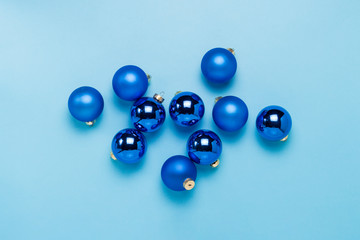 Blue Christmas tree toys, balls on a blue background. Concept of Merry Christmas and Happy New Year. Flat lay, top view