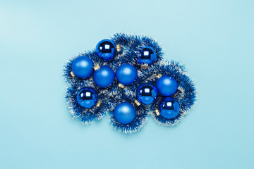 Blue Christmas tree toys, balls on a blue background. Concept of Merry Christmas and Happy New Year. Flat lay, top view