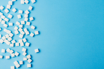 A lot of sugar cubes on a blue background.