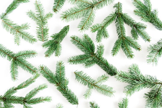 Christmas composition. Xmas pattern made of green fir tree branches on white background. Christmas, New Year, winter concept. Flat lay, top view, copy space 