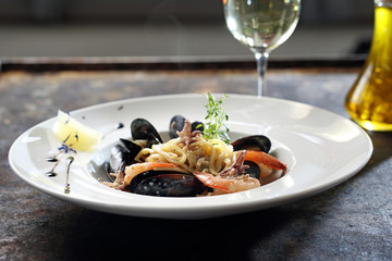 Makaron z owocami morza z białym winem. © foodandcook