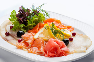 Appetizer of salted fish on white background