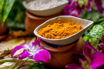 The massage or spa herbal set display in the container such as tumeric powder sesami seed salt 