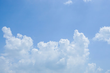 nature background - big white clouds in bright blue sky in summer