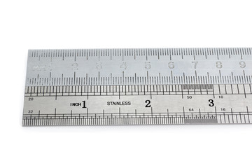 Two aligned metal measuring rulers in centimeters and inches