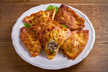 Savor crepes with meat filling. Crepes stuffed with beef sausage. horizontal
