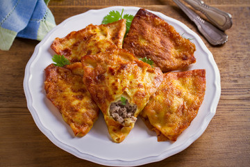 Savor crepes with meat filling. Crepes stuffed with beef sausage. horizontal