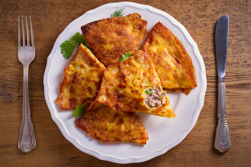 Savor crepes with meat filling. Crepes stuffed with beef sausage. overhead, horizontal