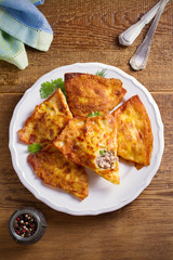 Savor crepes with meat filling. Crepes stuffed with beef sausage. overhead, vertical