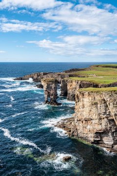 The cliffs of Yesnaby with the 35m high surf pillar, called Yesnaby Castle Sandwick, Mainland, Orkney Islands, Scotland, Great Britain