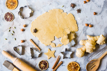 Cooking gingerbread cookies from dough using different forms - heart, star, Christmas tree. Winter...