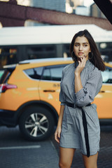 young lady crossing the bridge in the city