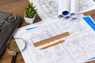 The architect's hands on the drawings are developing a construction plan. Business and Construction
