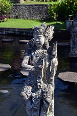 Statue in the Tirta Gangga water palace, a former royal palace. Karangasem regency, Bali, Indonesia.