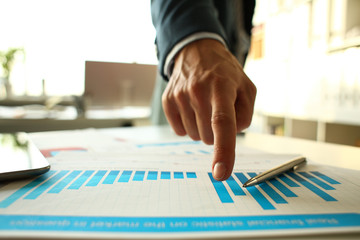 Male arm point finger at important paper