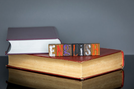English word from colored wooden letters on gray background. Education and knowledge concept