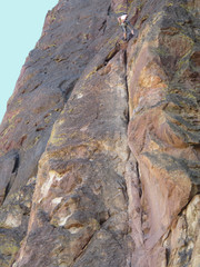 Rock climber and rope on cliff