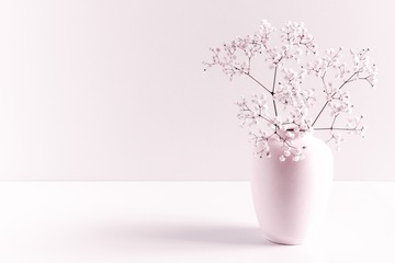 Home interior floral decor. Elegant floral soft pink composition. Beautiful flowers in vase on...