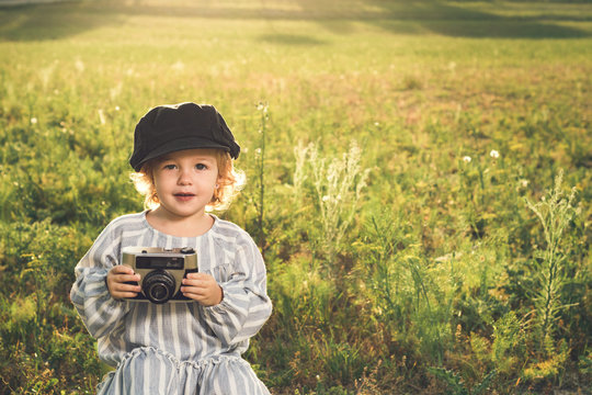 Portrait of a little girl taking pictures with a camera.Concept of children playing
