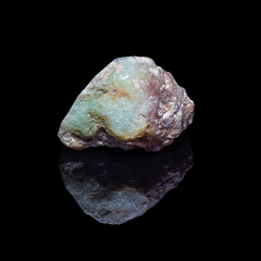 Natural polished opal stone on a black bacrground