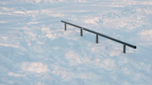 Skate boarding park in snowy winter city Park. Snow drifts on the hill to skateboard.