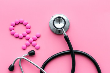 Female diseases concept. Stethoscope near female sign on pink background top view copy space