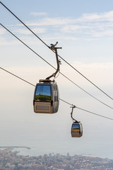 cable car in the mountains against the background of the city