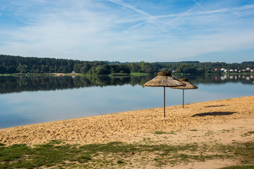 Umbrellas on the beach over the Brodzkie lake near Krynki, Swietokrzyskie, Poland